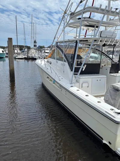  Yacht Photos Pics 2006 Rampage 38 Express boat docked in a marina, featuring a sleek design and fishing tower.