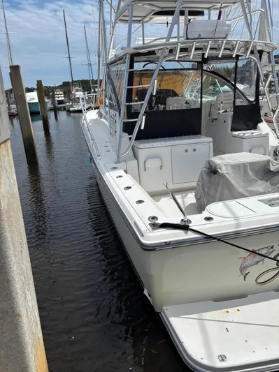  Yacht Photos Pics 2006 Rampage 38 Express boat docked at a marina, featuring a spacious deck and fishing equipment.