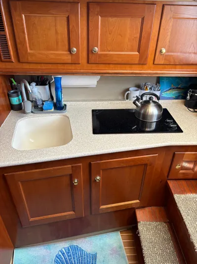  Yacht Photos Pics 2006 Rampage 38 Express yacht kitchen with wooden cabinets and modern appliances.