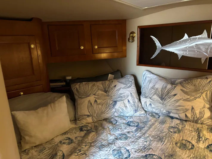  Yacht Photos Pics Cozy cabin interior of 2006 Rampage 38 Express with floral bedding and wooden cabinets.