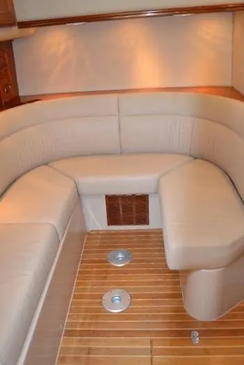  Yacht Photos Pics 2006 Rampage 38 Express interior with beige seating and wooden flooring.