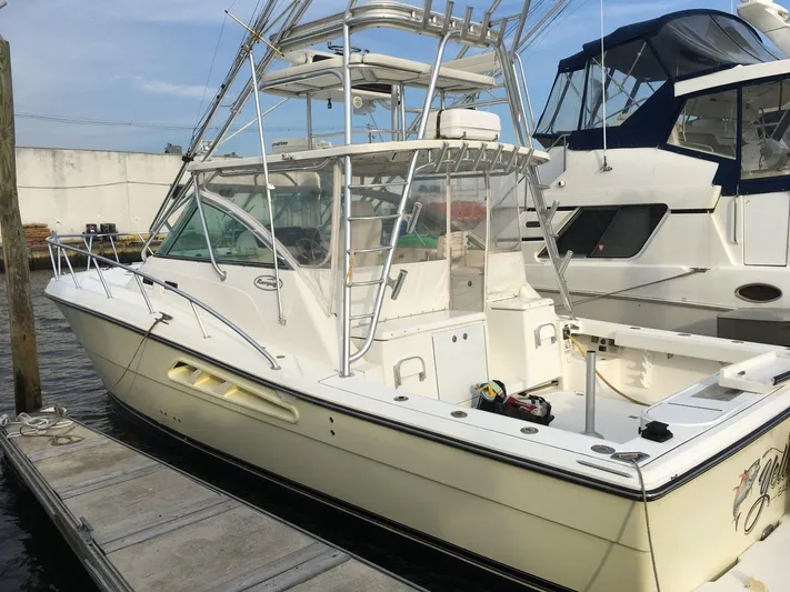  Yacht Photos Pics 2006 Rampage 38 Express boat docked at marina, featuring sleek design and fishing tower.