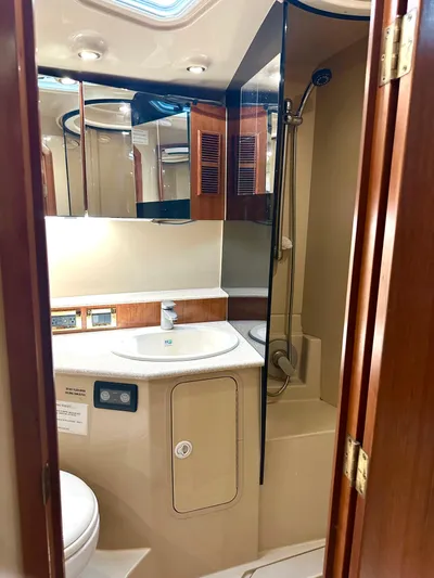  Yacht Photos Pics 2006 Rampage 38 Express yacht bathroom with shower, sink, and mirrored cabinets.