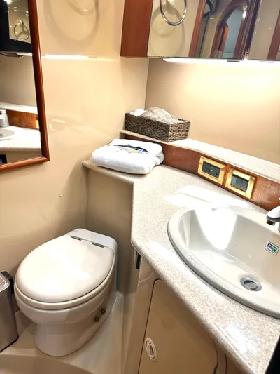  Yacht Photos Pics 2006 Rampage 38 Express yacht bathroom with sink, toilet, and mirror.