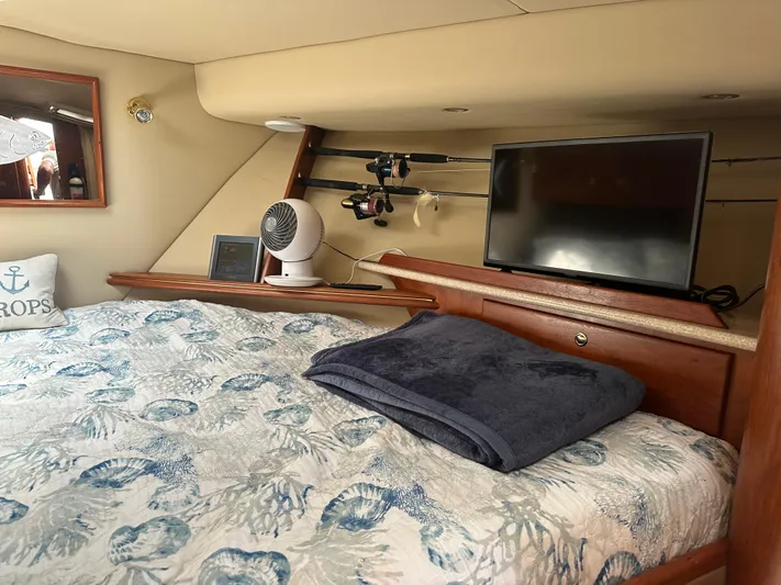  Yacht Photos Pics 2006 Rampage 38 Express cabin with bed, TV, and fan.