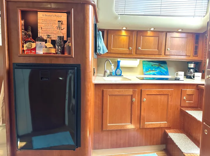  Yacht Photos Pics 2006 Rampage 38 Express yacht interior with wooden cabinetry and kitchenette.