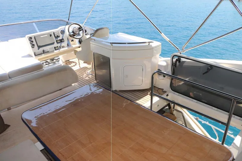  Yacht Photos Pics Flybridge of 2015 Absolute 56 FLY yacht with helm, seating, and ocean view.