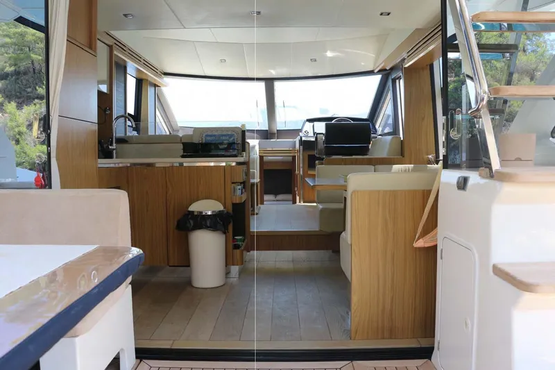  Yacht Photos Pics Interior of 2015 Absolute 56 FLY yacht, featuring modern wood finishes and spacious seating.