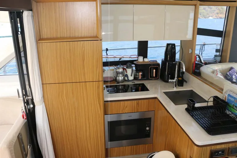  Yacht Photos Pics Modern kitchen interior on 2015 Absolute 56 FLY yacht with wood cabinetry and appliances.