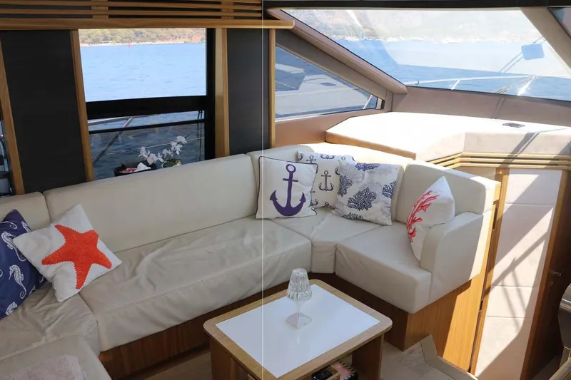  Yacht Photos Pics Luxurious interior of 2015 Absolute 56 FLY yacht with nautical-themed cushions.