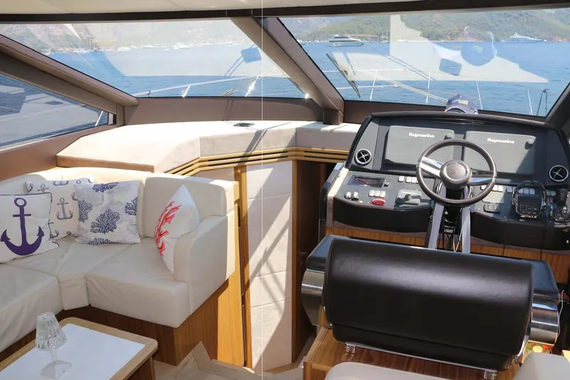  Yacht Photos Pics Luxurious interior of 2015 Absolute 56 FLY yacht with helm and seating area.