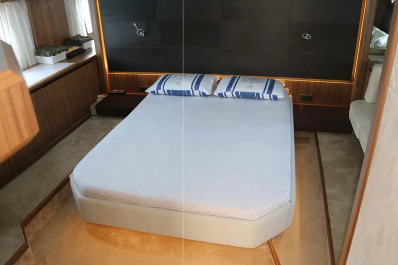  Yacht Photos Pics Luxurious bedroom interior of 2015 Absolute 56 FLY yacht with modern design elements.