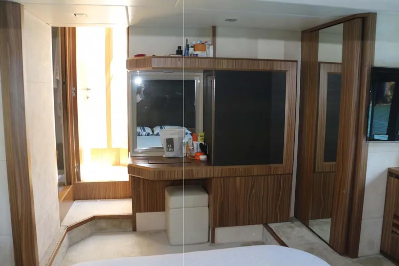  Yacht Photos Pics Luxurious interior of 2015 Absolute 56 FLY yacht with wooden accents and vanity area.