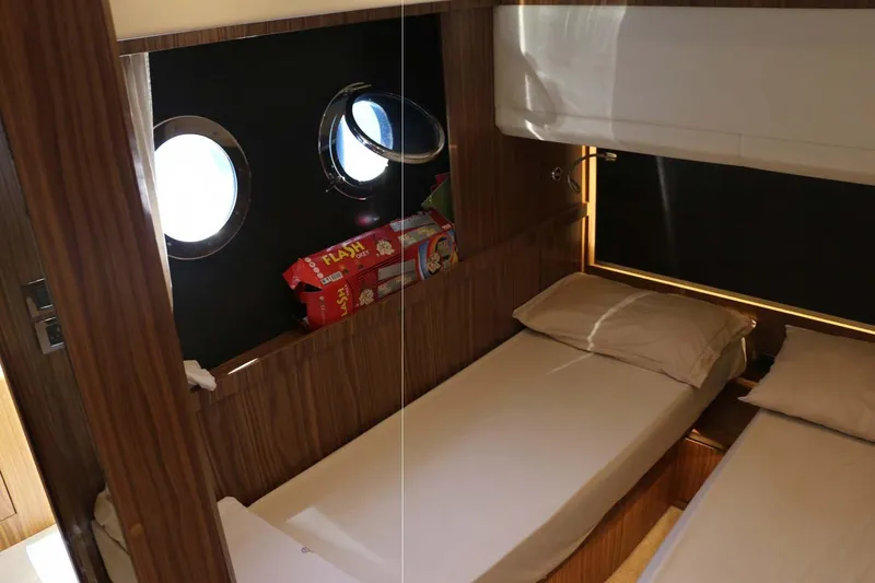  Yacht Photos Pics Cabin interior of 2015 Absolute 56 FLY yacht with twin beds and portholes.