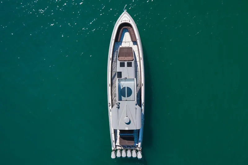  Yacht Photos Pics Aerial view of Midnight Express 52' Vitesse yacht on clear turquoise water.