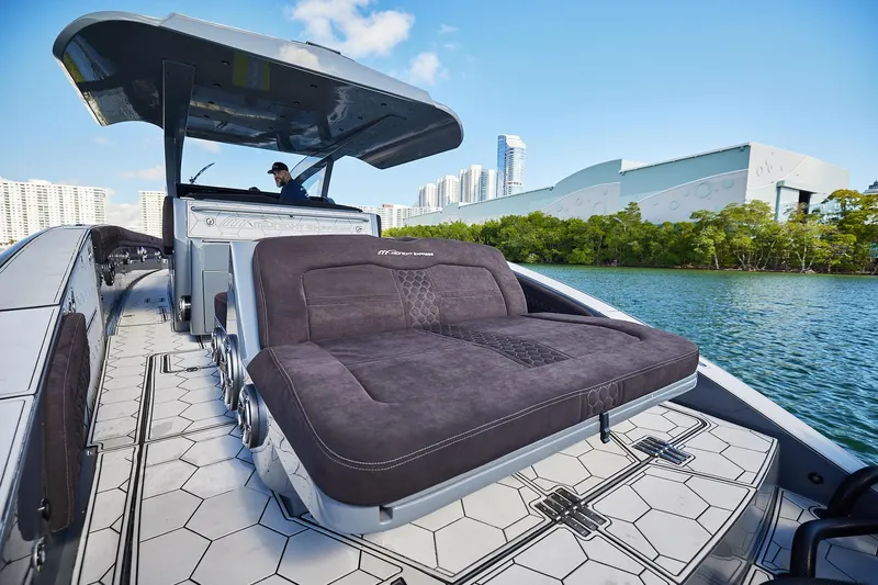  Yacht Photos Pics Luxury Midnight Express 52' Vitesse yacht with sleek design, cruising near modern cityscape.