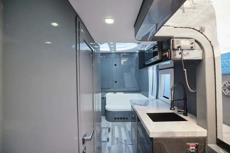  Yacht Photos Pics Luxurious interior of Midnight Express 52' Vitesse yacht with modern kitchenette and sleek design.