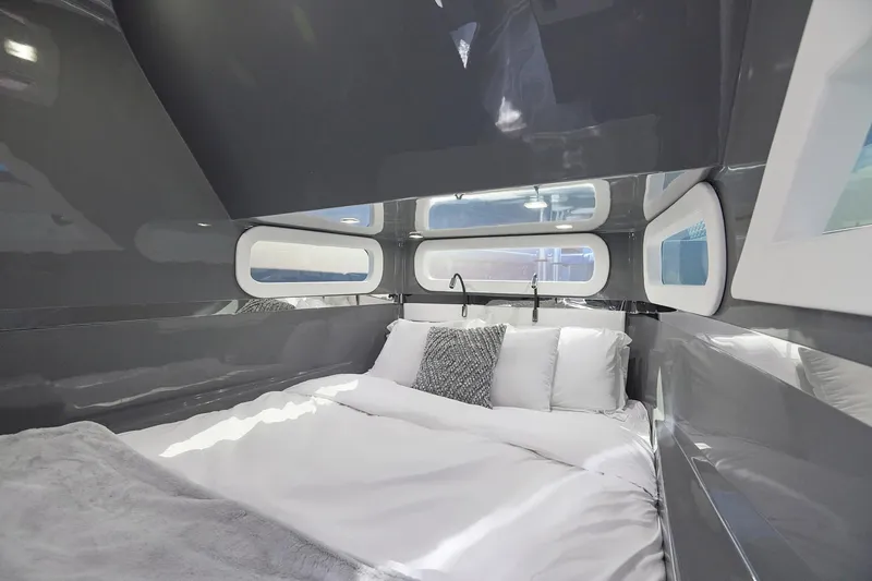  Yacht Photos Pics Luxurious cabin interior of Midnight Express 52' Vitesse yacht with modern bedding and sleek design.