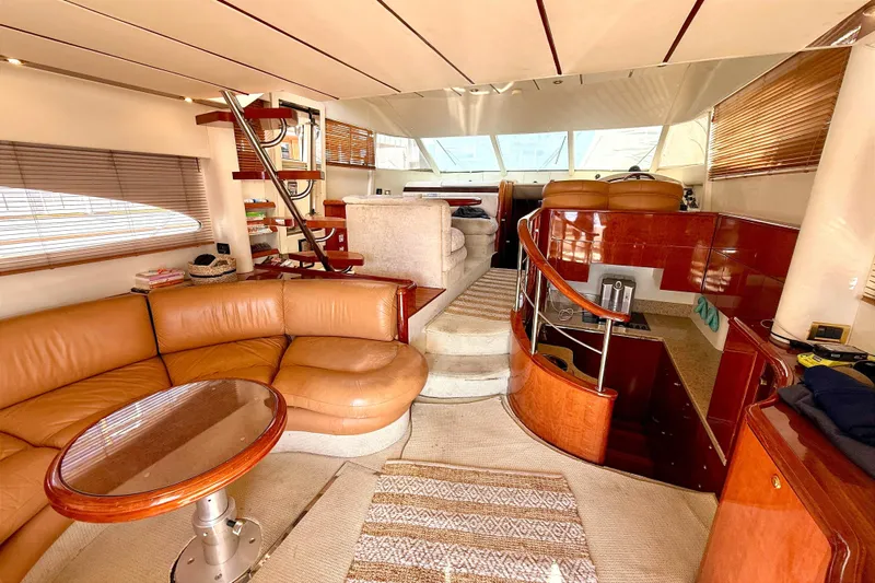  Yacht Photos Pics Luxurious interior of 2000 Fairline Squadron 55 yacht with leather seating and wooden accents.