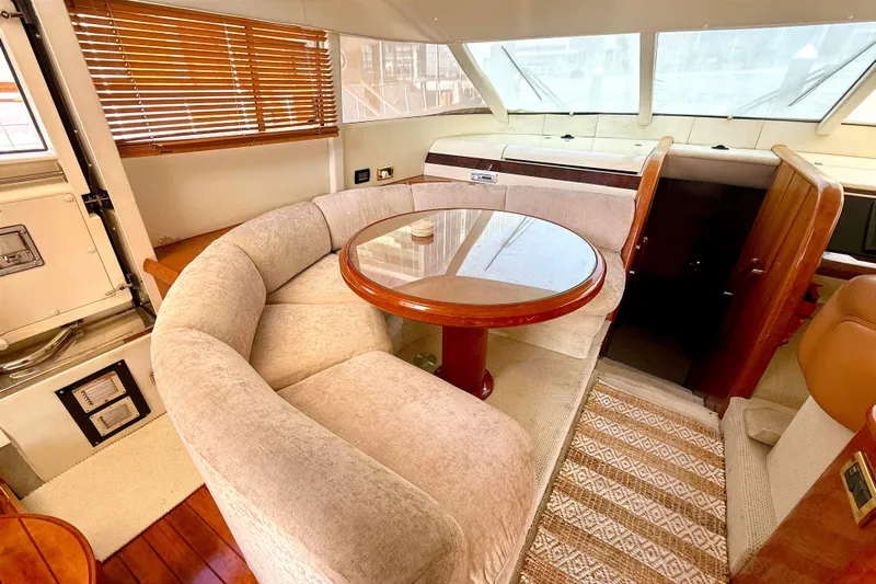  Yacht Photos Pics Luxurious interior of 2000 Fairline Squadron 55 yacht with plush seating and wooden table.