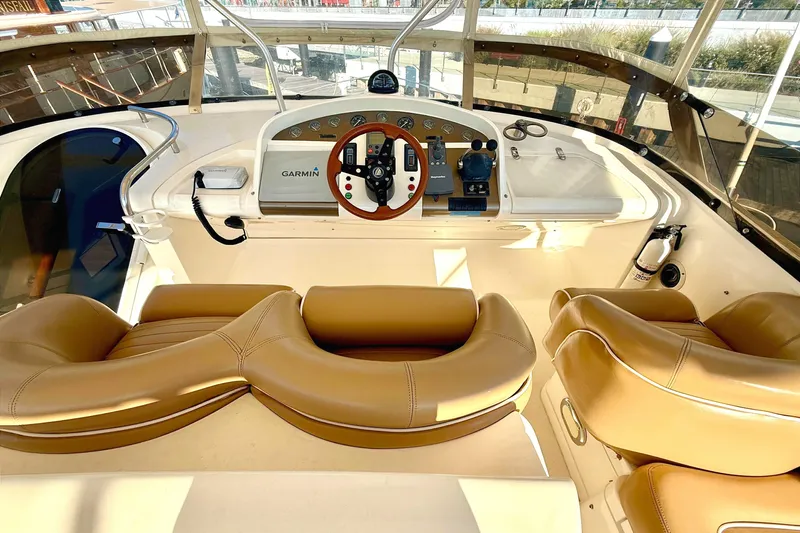  Yacht Photos Pics Cockpit of 2000 Fairline Squadron 55 yacht with tan leather seats and Garmin navigation.
