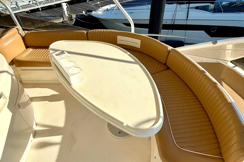  Yacht Photos Pics Luxurious seating area on a 2000 Fairline Squadron 55 yacht with a sleek table.
