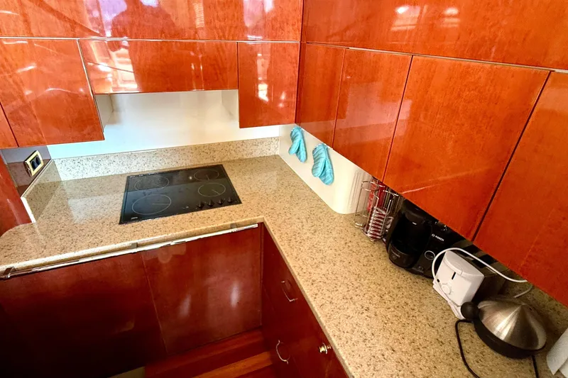  Yacht Photos Pics Luxurious kitchen in 2000 Fairline Squadron 55 yacht with sleek wooden cabinets.