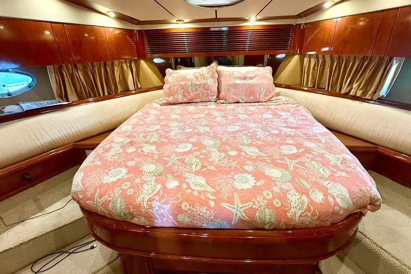  Yacht Photos Pics Luxurious cabin interior of 2000 Fairline Squadron 55 yacht with elegant bedding.