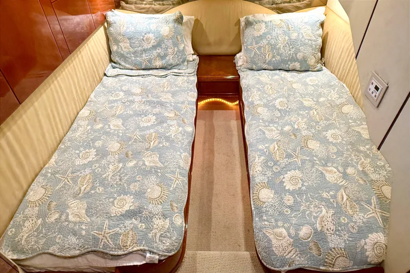  Yacht Photos Pics Twin beds with seashell-patterned bedding in a 2000 Fairline Squadron 55 yacht cabin.