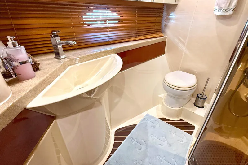  Yacht Photos Pics Luxurious bathroom in 2000 Fairline Squadron 55 yacht with modern fixtures and elegant design.