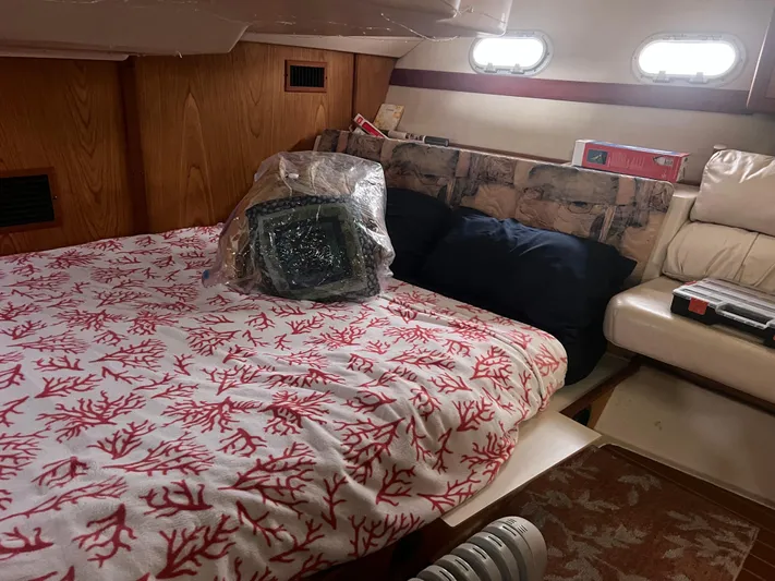 "helluva" Yacht Photos Pics Cozy cabin interior of 2000 Hunter 410 sailboat with coral-patterned bedding.