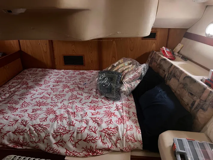 "helluva" Yacht Photos Pics Cozy cabin interior of a 2000 Hunter 410 sailboat with a patterned bedspread.