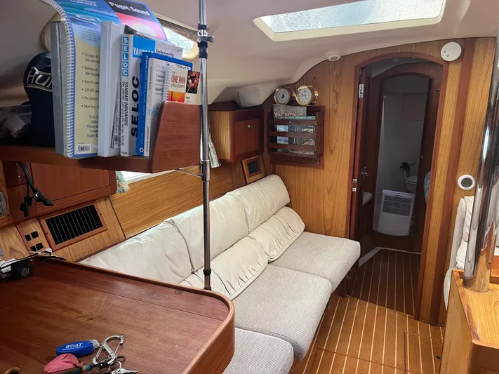"helluva" Yacht Photos Pics Interior of 2000 Hunter 410 sailboat with cozy seating and wooden finish.