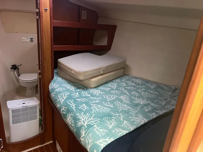 "helluva" Yacht Photos Pics Cozy cabin interior of 2000 Hunter 410 sailboat with bed and compact bathroom.