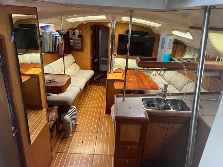 "helluva" Yacht Photos Pics Interior of 2000 Hunter 410 sailboat with wood finish and cozy seating area.