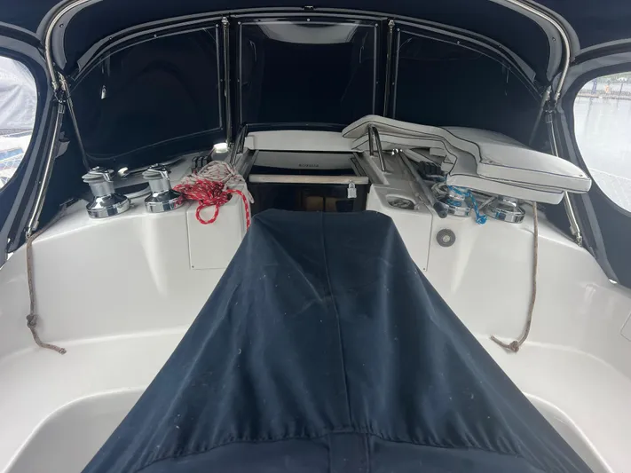 "helluva" Yacht Photos Pics Interior view of a 2000 Hunter 410 sailboat cockpit with covered seating and winches.