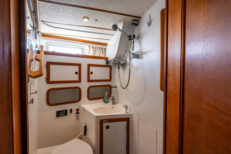 Emeritus Yacht Photos Pics Nauticat 35 Pilot House 2000 bathroom with wooden accents and compact design.