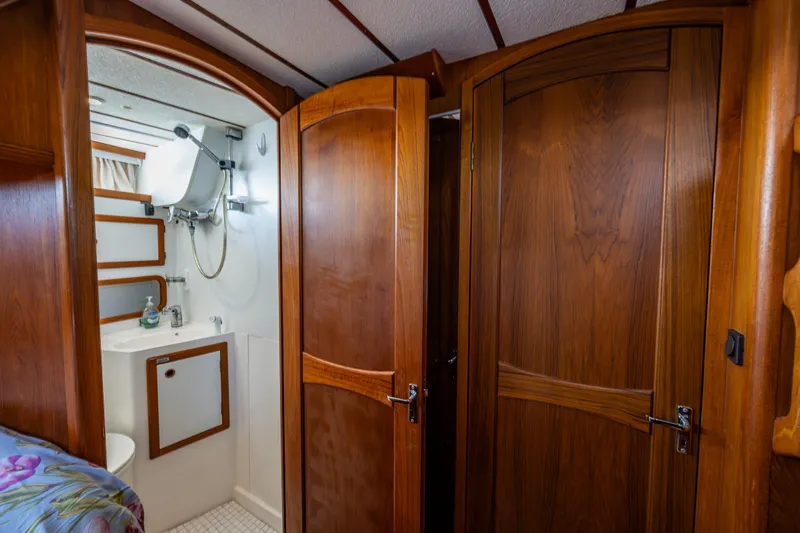 Emeritus Yacht Photos Pics Interior of 2000 Nauticat 35 Pilot House, featuring wooden doors and compact bathroom.