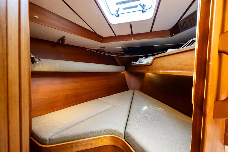 Emeritus Yacht Photos Pics Cozy cabin interior of 2000 Nauticat 35 Pilot House with wooden finish and skylight.