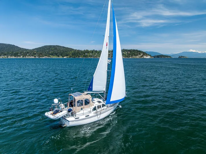 Emeritus Yacht Photos Pics Sailboat Nauticat 35 Pilot House 2000 cruising on a scenic blue ocean.