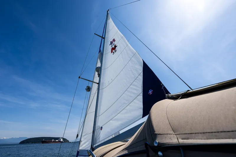 Emeritus Yacht Photos Pics Sailing on a 2000 Nauticat 35 Pilot House under clear blue skies.