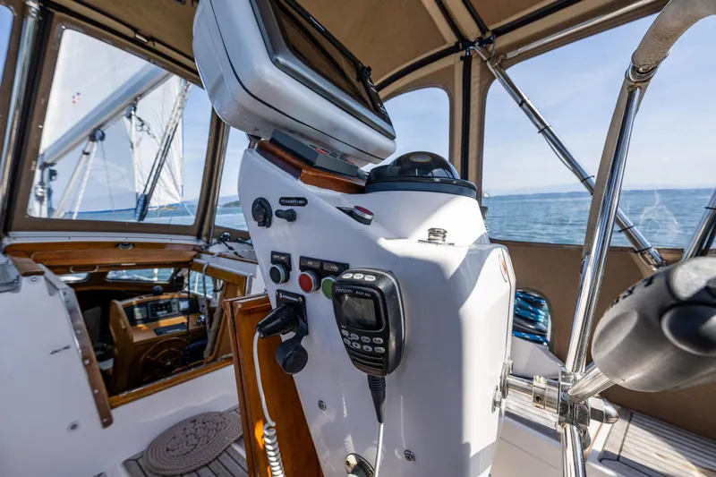 Emeritus Yacht Photos Pics Pilot house of 2000 Nauticat 35 sailboat with navigation equipment and ocean view.