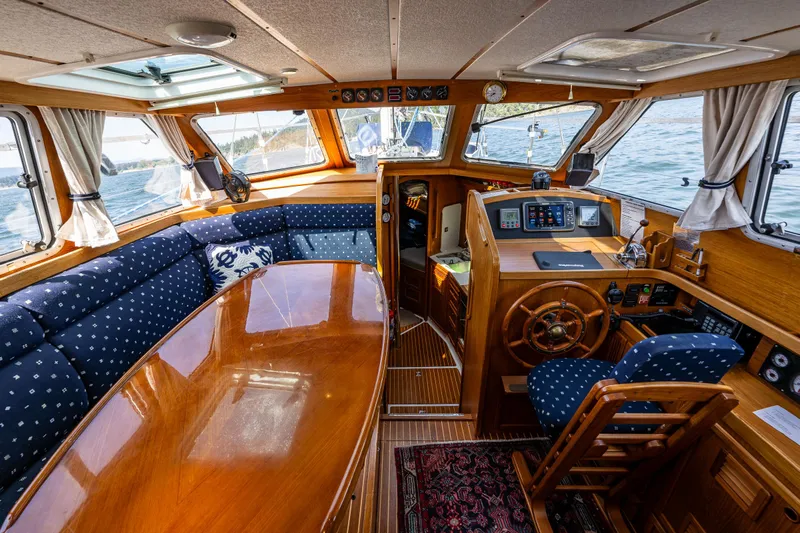 Emeritus Yacht Photos Pics Nauticat 35 Pilot House 2000 interior with wooden finish and nautical decor.