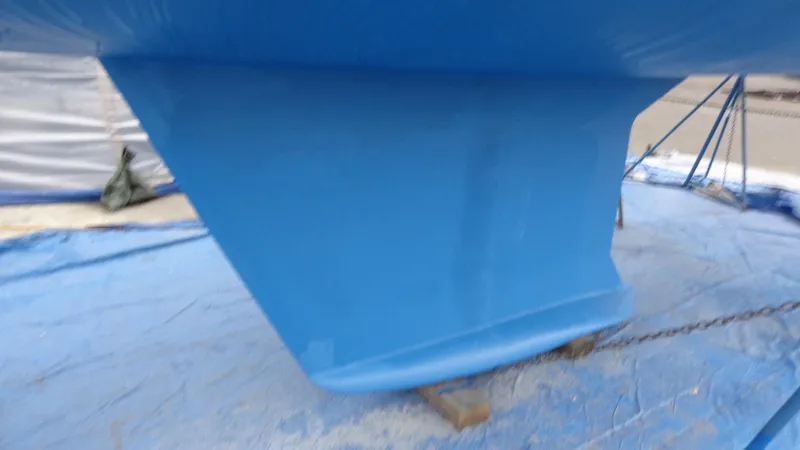 "helluva" Yacht Photos Pics Blue keel of a 2000 Hunter 410 sailboat on a tarp.