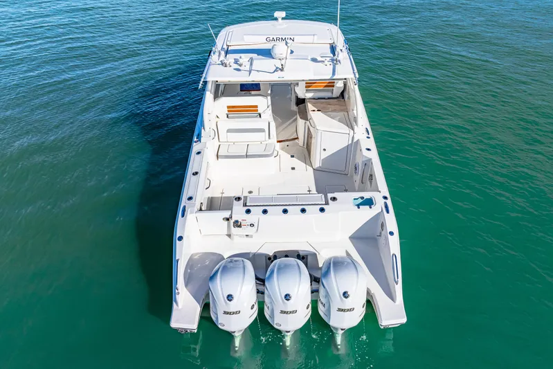 Conspirasea Yacht Photos Pics 2021 Pursuit DC 365 Dual Console boat with triple engines on clear water.