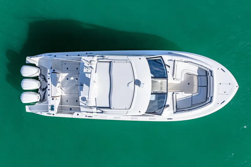Conspirasea Yacht Photos Pics 2021 Pursuit DC 365 Dual Console boat on clear turquoise water, aerial view.