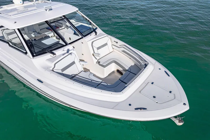 Conspirasea Yacht Photos Pics 2021 Pursuit DC 365 Dual Console boat on clear water, showcasing sleek design and spacious seating.