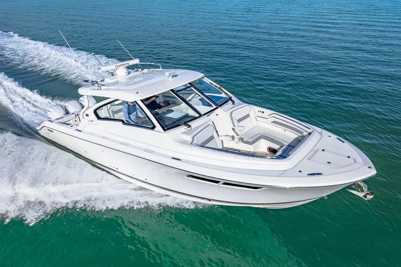 Conspirasea Yacht Photos Pics 2021 Pursuit DC 365 Dual Console boat cruising on clear blue water.