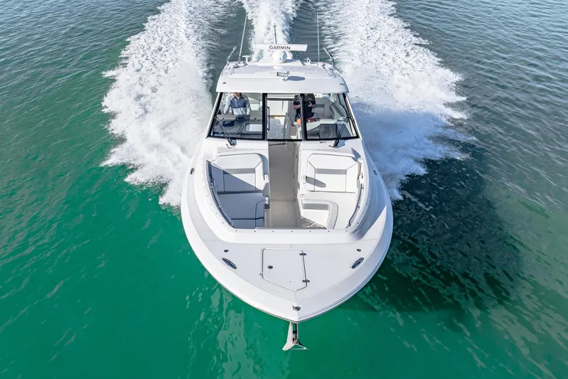 Conspirasea Yacht Photos Pics 2021 Pursuit DC 365 Dual Console boat cruising on clear turquoise water.