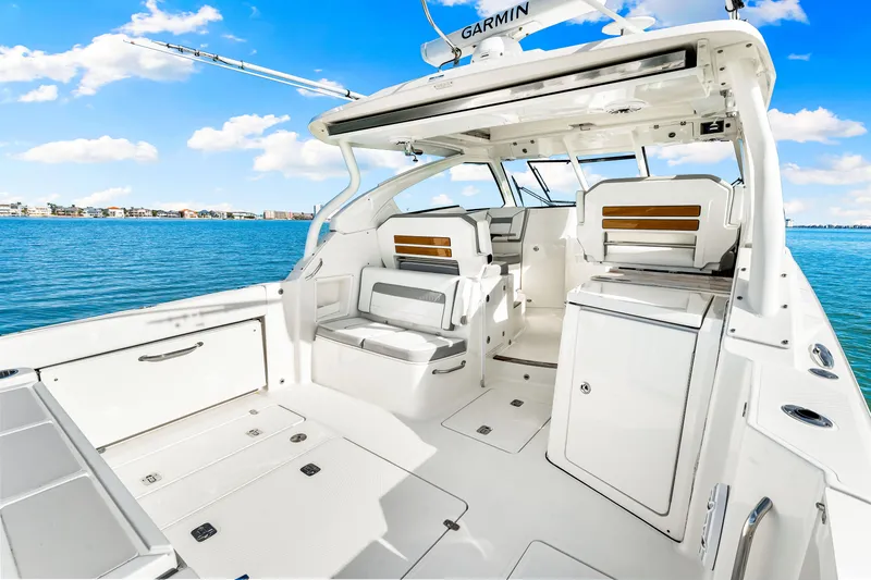 Conspirasea Yacht Photos Pics 2021 Pursuit DC 365 Dual Console boat interior with seating, ocean view, and clear sky.